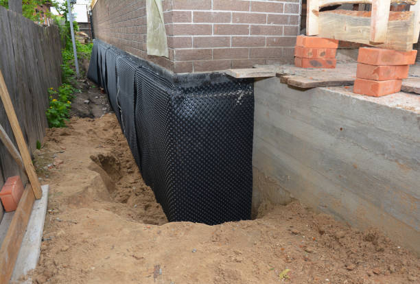 Happy homeowners after waterproofing job in Huntington